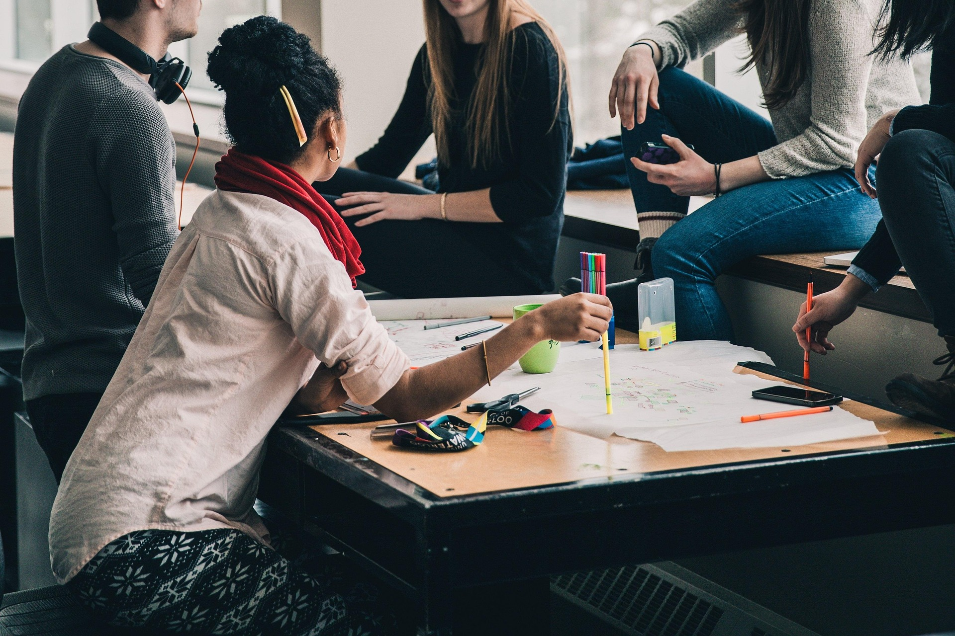 Young people collaborating around a shared table.