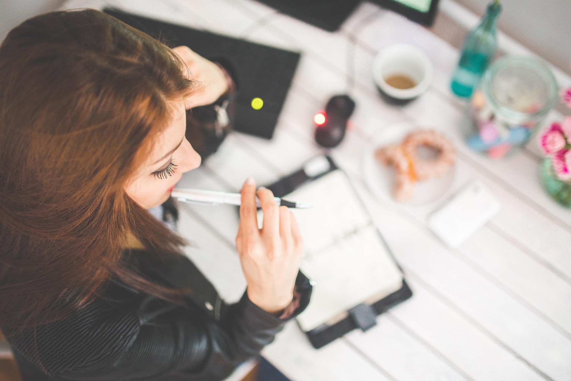 Woman working at a desk in an office setting.
